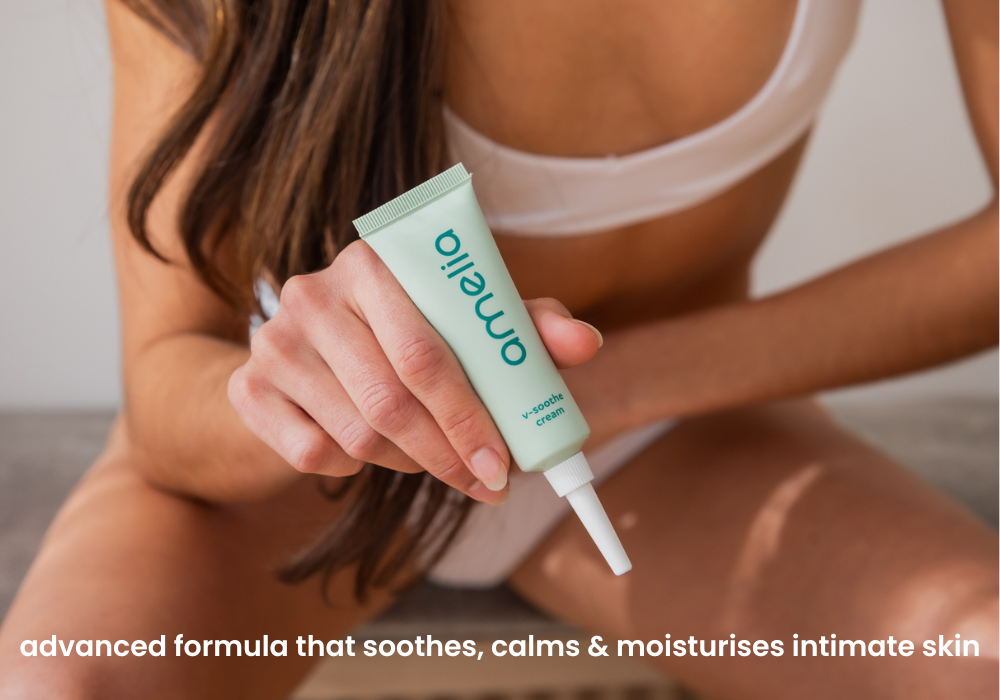 Person holding a green and white tube of Amelia v-soothe cream